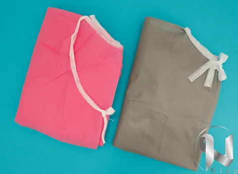 تصویر 1 از گان یکبار مصرف صورتی گزینه مناسب مصرف در فضای درمان